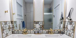 a bathroom with two sinks and a mirror at Luxury 4-BR House Tampa Downtown Oasis w Cottage in Tampa