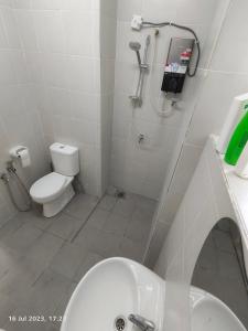 a bathroom with a shower and a toilet and a sink at Balcony Forest Lake Mountain in Kampar