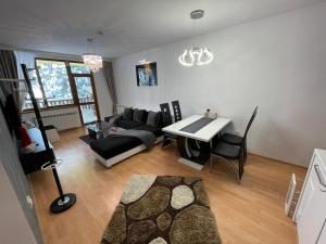 a living room with a couch and a table at Luxury Apartament in "Sequoia" 2 in Borovets