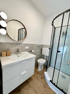 a bathroom with a sink and a mirror at SmartRooms24 in Villach