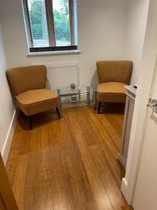 two chairs and a glass table in a room at Self contained 1 bedroom in Windsor