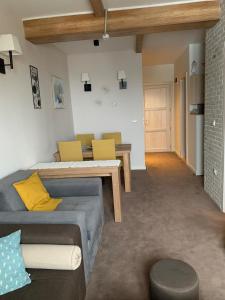 a living room with a couch and a table at Apartment Župa 111, Župa Wellness & Spa, Kopaonik in Kopaonik