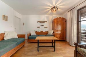 a bedroom with a bed and a table in it at Holiday Home Kersnik in Bohinj