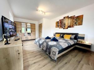 a bedroom with a bed and a television in it at Ferienhaus Lieblingsplatz in Blaibach