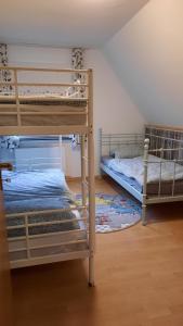 a bedroom with two bunk beds and a rug at YALET Ferienhaus Willingen in Brilon-Wald