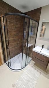 a bathroom with a shower and a sink at Northlea-Scottish style cottage in Inverness