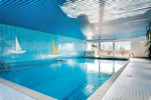 a large swimming pool with a blue wall and blue tiles at Haus Mitterbach Ferienwohnung Berglaune in Berchtesgaden