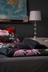 a bed with a blanket on it with a lamp at Joensuun kalastajan helmi in Joensuu