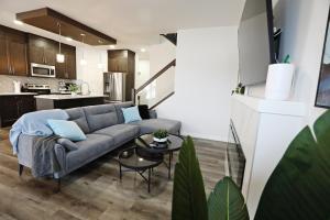 a living room with a couch and a kitchen at Three King Beds,Central A/C,Fireplace,Park,Disney+ in Edmonton