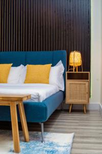 a blue couch in a room with a table at BeHomu Apartments Kampala in Kira +10 photos