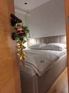 a bedroom with a bed with a christmas decoration at Apartman 305 Zlatni Javor in Jahorina +8 photos