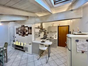 a large kitchen with a sink and a refrigerator at L’Angolo di Pace in Massa Lombarda