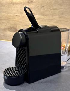 a black toaster sitting on top of a counter at Apartmány LUXOR in Česká Lípa