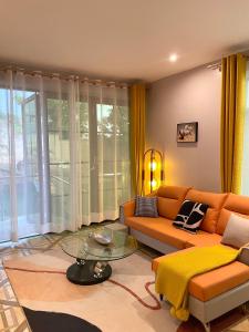 a living room with a couch and a glass table at Keitylin Heights Apartments in Makindye in Kampala