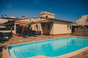 a swimming pool in front of a house at Casa Tati in Sant Pere Pescador