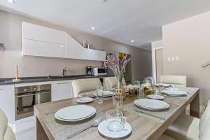a kitchen and dining room with a wooden table and chairs at Large Luxury apartment on Palm Beach in Palm-Eagle Beach