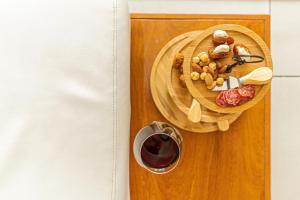 a plate of food and a glass of red wine at Large Luxury apartment on Palm Beach in Palm-Eagle Beach