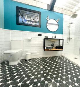 a bathroom with a toilet and a mirror at Casa Encina in Murcia