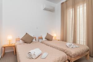 a bedroom with two beds with towels on them at SeaView Apartment 2 in Samos