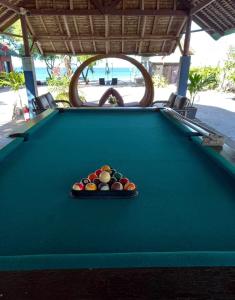 a pool table with a tray of balls on it at The Nova Scotia Resort Botolan in Binuclutan