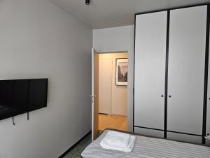 a bedroom with a bed and a tv on a wall at Apartament Ogrodowa in Łódź +7 photos