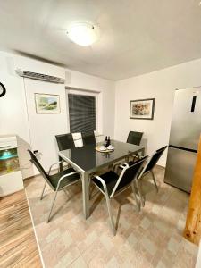 a dining room with a table and chairs and a refrigerator at Riverhouse apartment in Radovljica +11 photos