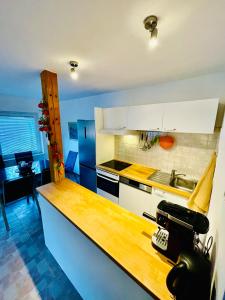 a kitchen with white cabinets and a counter top at Riverhouse apartment in Radovljica