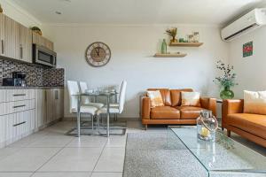 a living room with a couch and a table at Affordable family apartment only 350 yards from Eagle Beach in Palm-Eagle Beach