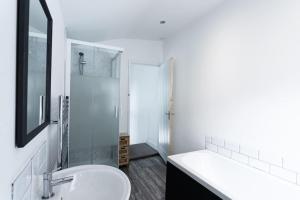 a white bathroom with a sink and a shower at 2/3 Bed House in the centre of Northampton in Northampton