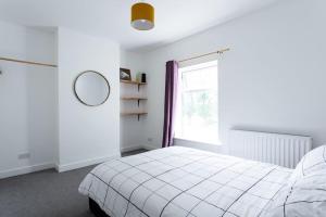 a white bedroom with a bed and a window at 2/3 Bed House in the centre of Northampton in Northampton