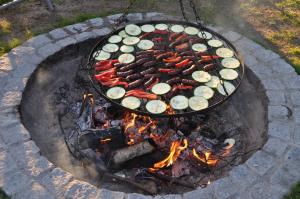 a grill with a bunch of meats and vegetables on at Kleine weisse Doppelhaushälfte in Częstochowa