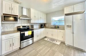 kuchnia z białymi szafkami i białą lodówką w obiekcie Lovely Home 30MIN to Berkeley, SF, Napa w mieście Pinole