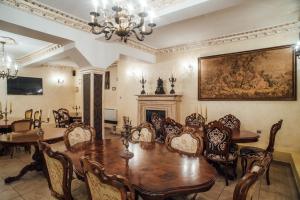 a dining room with a table and chairs and a fireplace at Veritas Boutique Vila in Craiova