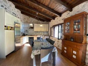a kitchen and dining room with a table and a refrigerator at Vista Mora Sierra Cazorla in La Iruela