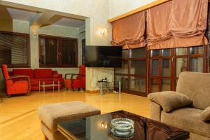 a living room filled with furniture and a flat screen tv at RESIDENTIAL HOUSE in Sarajevo