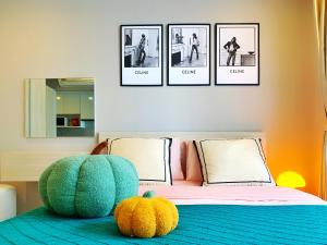 a bedroom with a bed with three pictures on the wall at Palm Springs Fountain Nimman Condominium in Chiang Mai