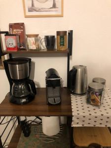 a counter with a coffee maker and a mixer on it at Appartement BELLO , ruelle au cœur de ville, arrivée en autonomie in Lons-le-Saunier