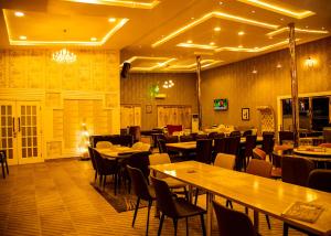 a restaurant with tables and chairs in a room at Portland Resort Hotel in Port Harcourt