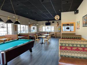 a pool table in a restaurant with tables and chairs at Country Inn & Suites by Radisson, Prairie du Chien, WI in Prairie du Chien