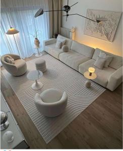 a living room with a white couch and tables at Entre Mer et Lac de la Goulette in La Goulette