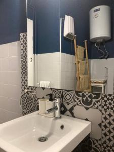 a bathroom with a sink and a mirror at Retro living apartment in Larisa