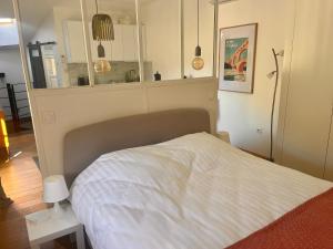 a bedroom with a bed with a white bedspread at Les Cerises du Pont du Gard in Remoulins