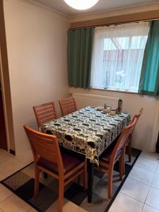 a dining room table with chairs and a table cloth on it at The best known village of Belgium in Puurs