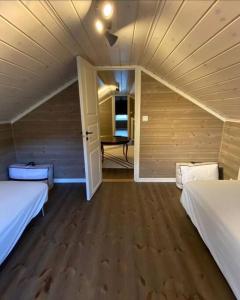 a room with two beds and an open door at Koselig, nyere hytte til leie in Stranda