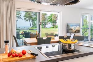 a kitchen with a counter with vegetables on a table at Terrassenwohnung "Inselhain" - Oase am Haff in Garz-Usedom