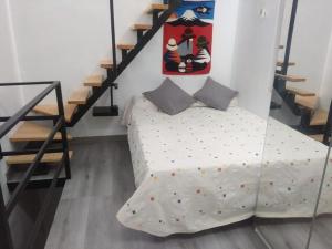 a bedroom with a bed and a staircase at Christian in Cruce de Arinaga