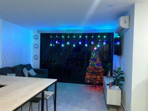 a living room with a christmas tree in a window at Paradise Apartment in San Salvador