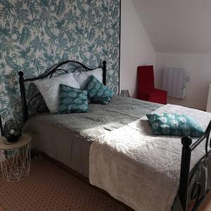 a bedroom with a bed with pillows on it at Maison de la plage 