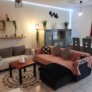 a living room with a couch and a table at Maison de la plage 