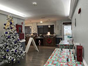 a living room with a christmas tree and christmas gifts at Budgetel Chattanooga in Chattanooga